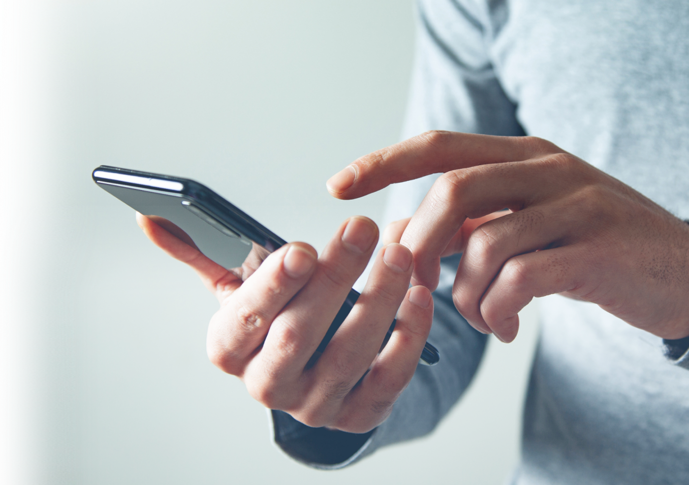 hands using smartphone for financial app interaction